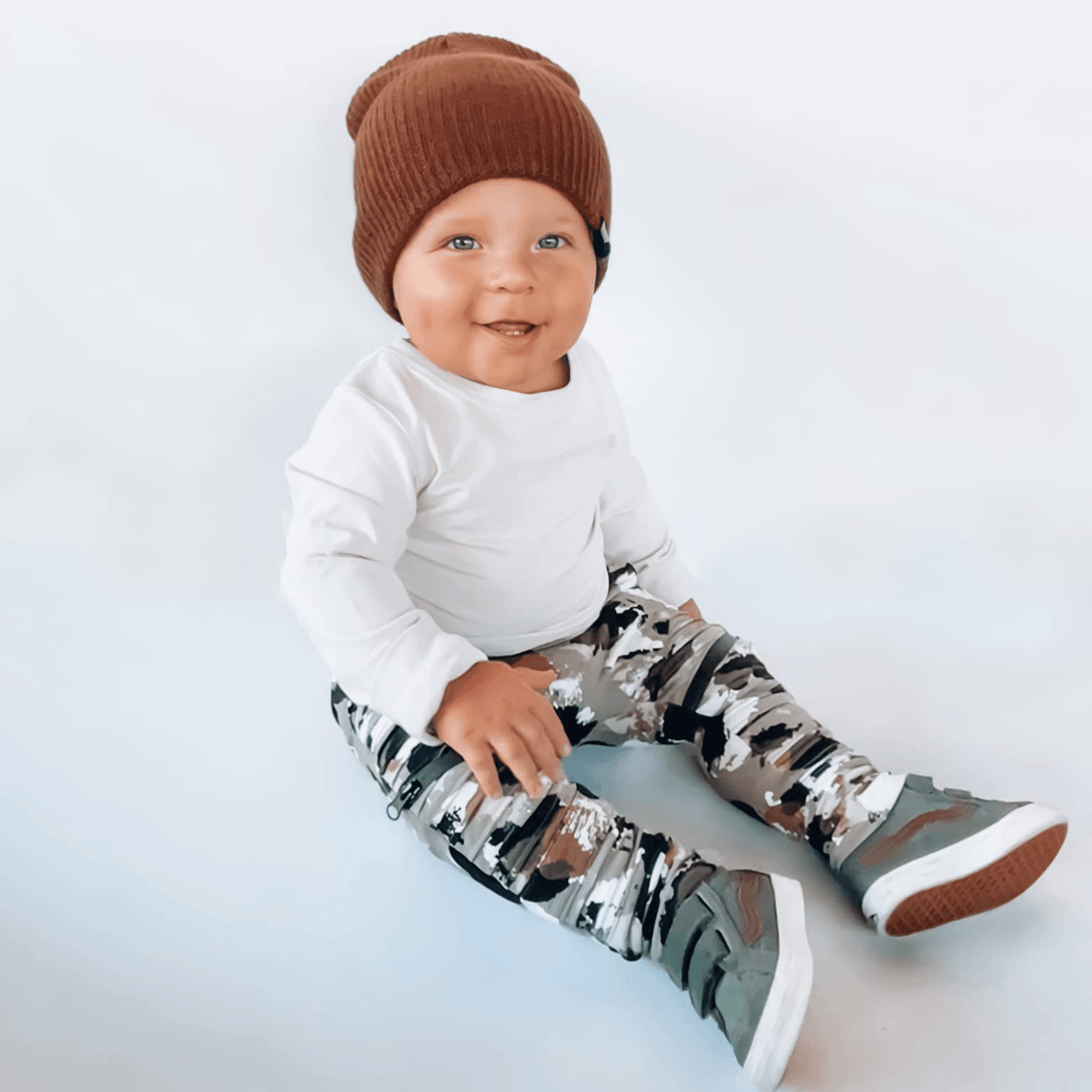 Image of Brown Kids Beanie with Knuckleheads Logo: A stylish and cozy accessory for kids. In a charming green color, it features the iconic Knuckleheads logo on the front. Elevate your child's style with this fashionable beanie, perfect for adding a touch of character to their outfits while keeping them warm.