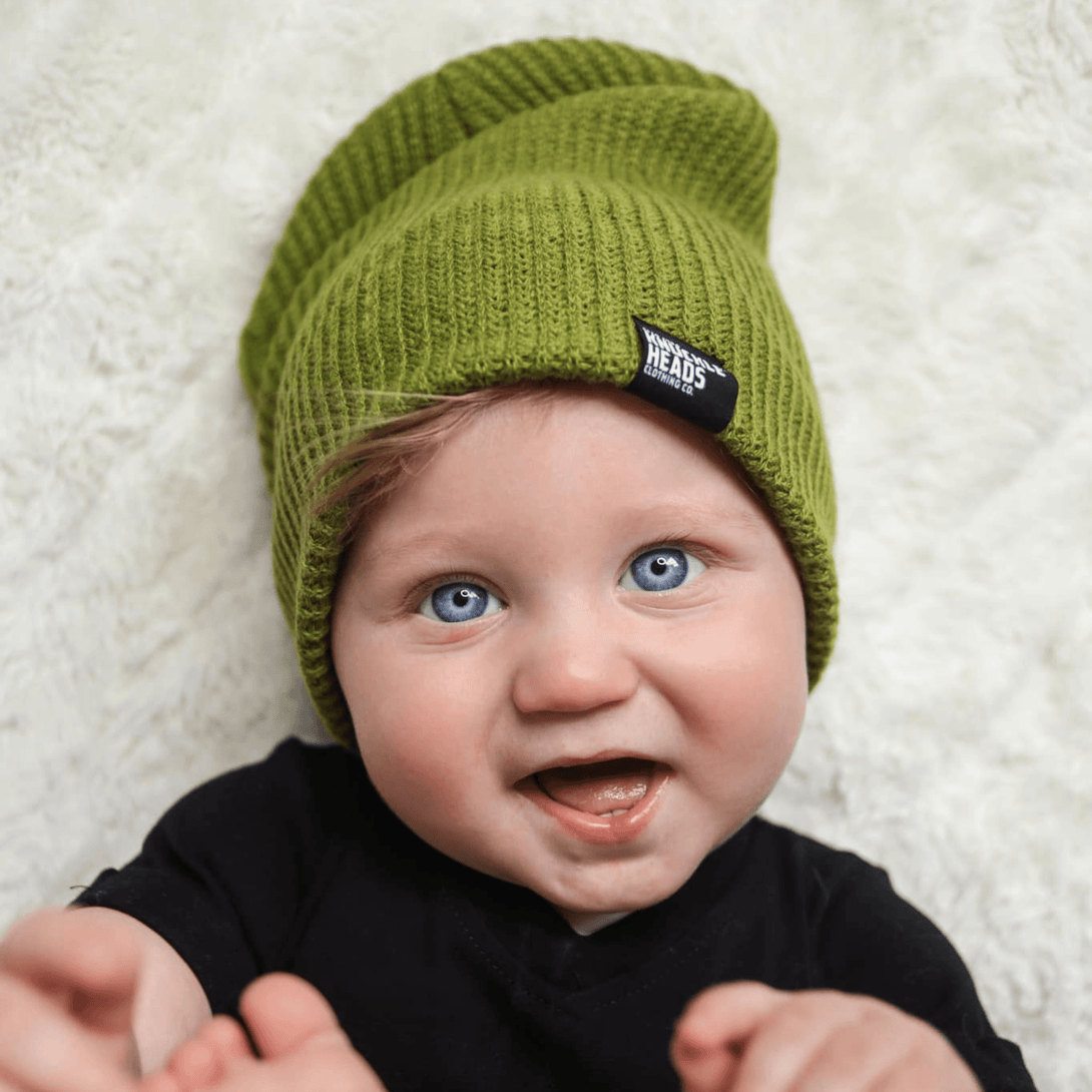 Image of Green Kids Beanie with Knuckleheads Logo: A stylish and cozy accessory for kids. In a charming green color, it features the iconic Knuckleheads logo on the front. Elevate your child's style with this fashionable beanie, perfect for adding a touch of character to their outfits while keeping them warm.
