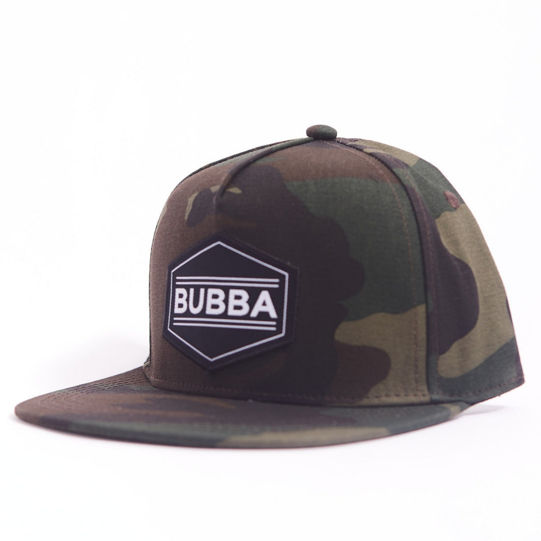 Presenting the Adventurous Kids Trucker Hat with 'Bubba' Patch: A trendy and stylish accessory designed for kids. In a cool camo pattern, it features a fun 'Bubba' patch on the front. Elevate your child's style with this fashionable hat, perfect for adding a touch of outdoor charm to their outfits.