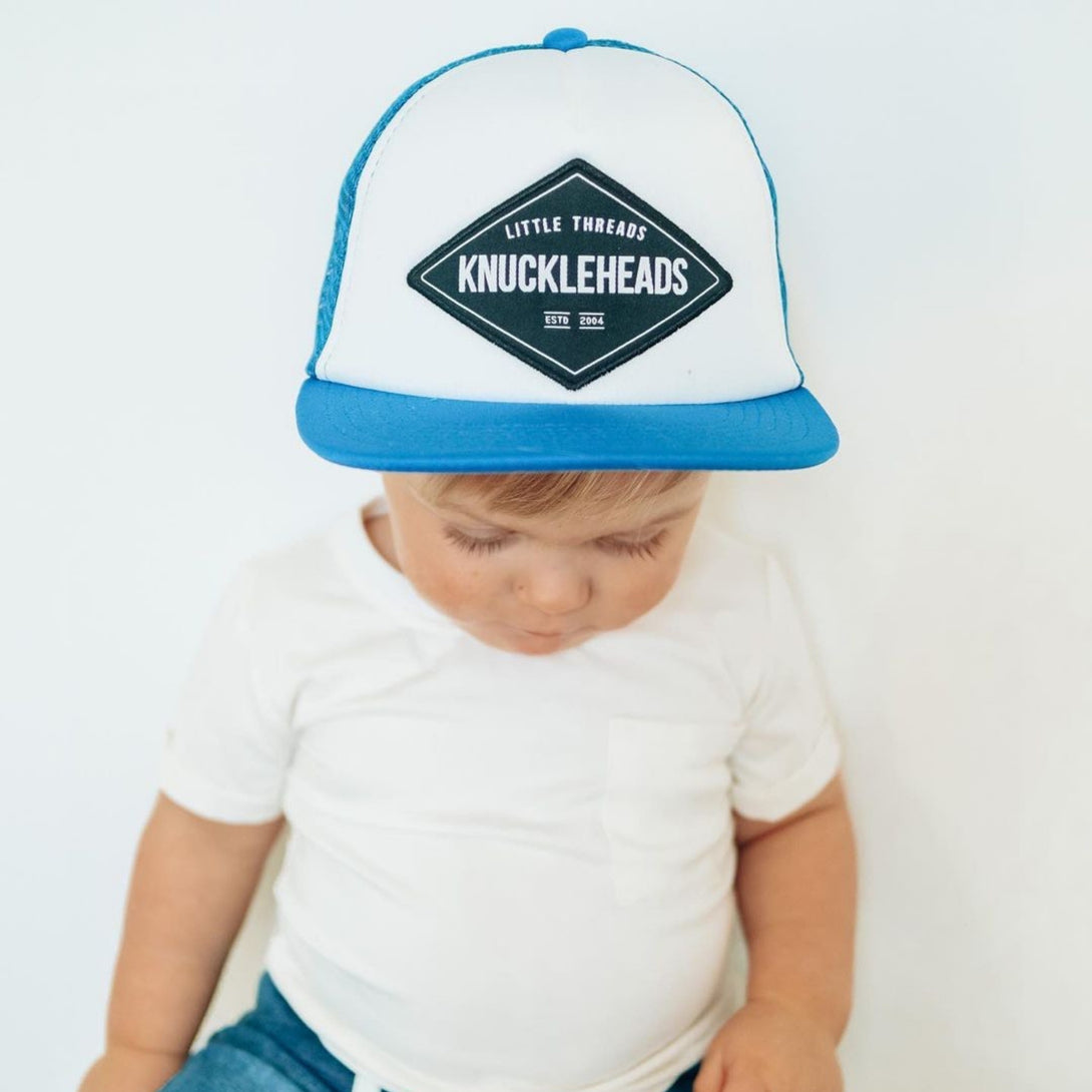 Image of Blue Kids Trucker Hat with Knuckleheads Patch: A stylish and versatile accessory designed for kids. In a captivating blue hue, it showcases a striking Knuckleheads patch on the front. Elevate your child's style with this fashionable hat, perfect for adding a pop of color to their outfits.