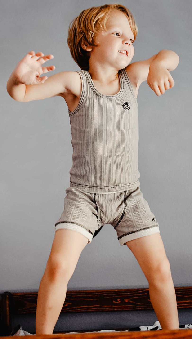 An image of Knuckleheads Logo Light Grey Skivvies for Kids, showcasing stylish black underwear with the iconic Knuckleheads logo. These comfortable and trendy undergarments are perfect for children, combining fashion and comfort seamlessly.