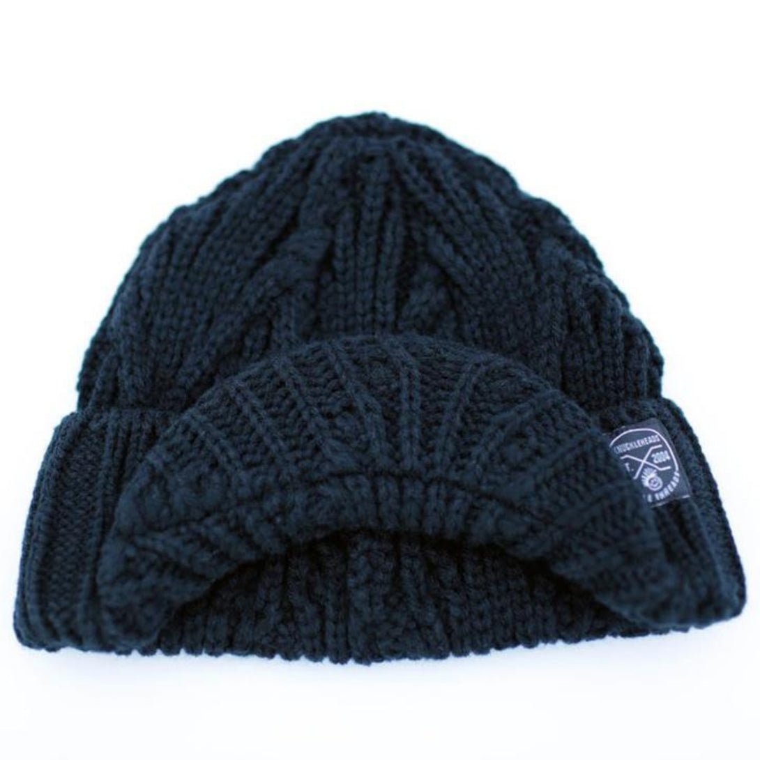 Image of a black knit beanie for kids, showcasing a Knuckleheads tag and a visor. The intricate knit pattern adds texture to the beanie's design, offering a blend of fashion and functionality.