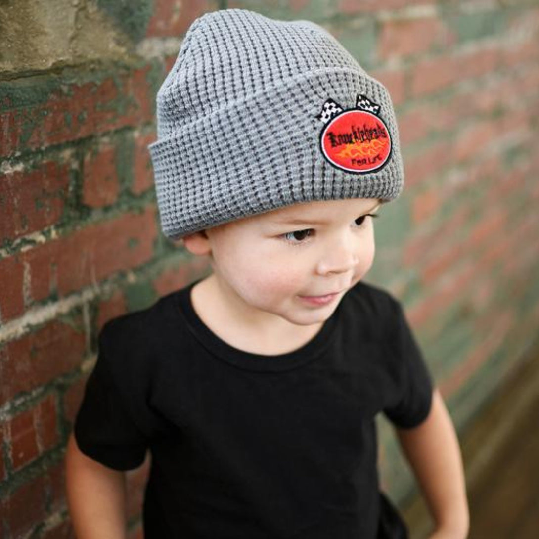 Image of a fold-up gray beanie from Knuckleheads, designed for children. This versatile beanie offers a classic style with the Knuckleheads brand tag, suitable for infants and toddlers. A part of the charming collection of Infant hats for added appeal.