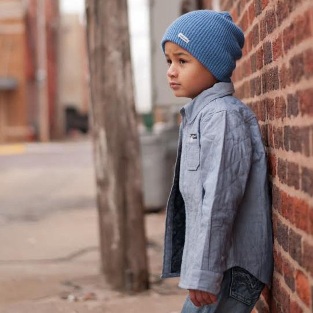 Image of a light blue slouchy beanie by Knuckleheads, designed for children. This versatile beanie offers a relaxed style with the Knuckleheads brand tag, suitable for infants and toddlers. A part of the charming collection of Infant hats for added appeal.