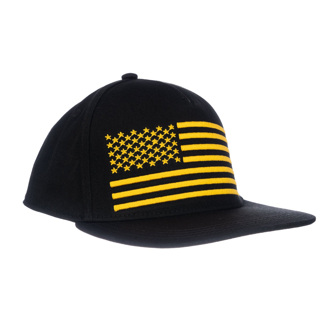Image of Black Kids Trucker Hat with Gold USA Flag Patch: A patriotic and stylish accessory designed for kids. In classic black, it features a distinguished gold USA flag patch on the front. Elevate your child's style with this fashionable hat, perfect for adding a touch of elegance and national pride to their outfits.
