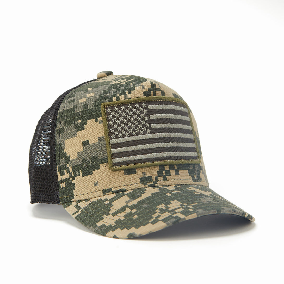 Image of Camo Kids Trucker Hat with Black Mesh and USA Flag Patch: A patriotic and stylish accessory designed for kids. In a captivating camo pattern with sleek black mesh, it features a prominent USA flag patch on the front. Elevate your child's style with this fashionable hat, perfect for adding a touch of national pride to their outfits while ensuring breathability.