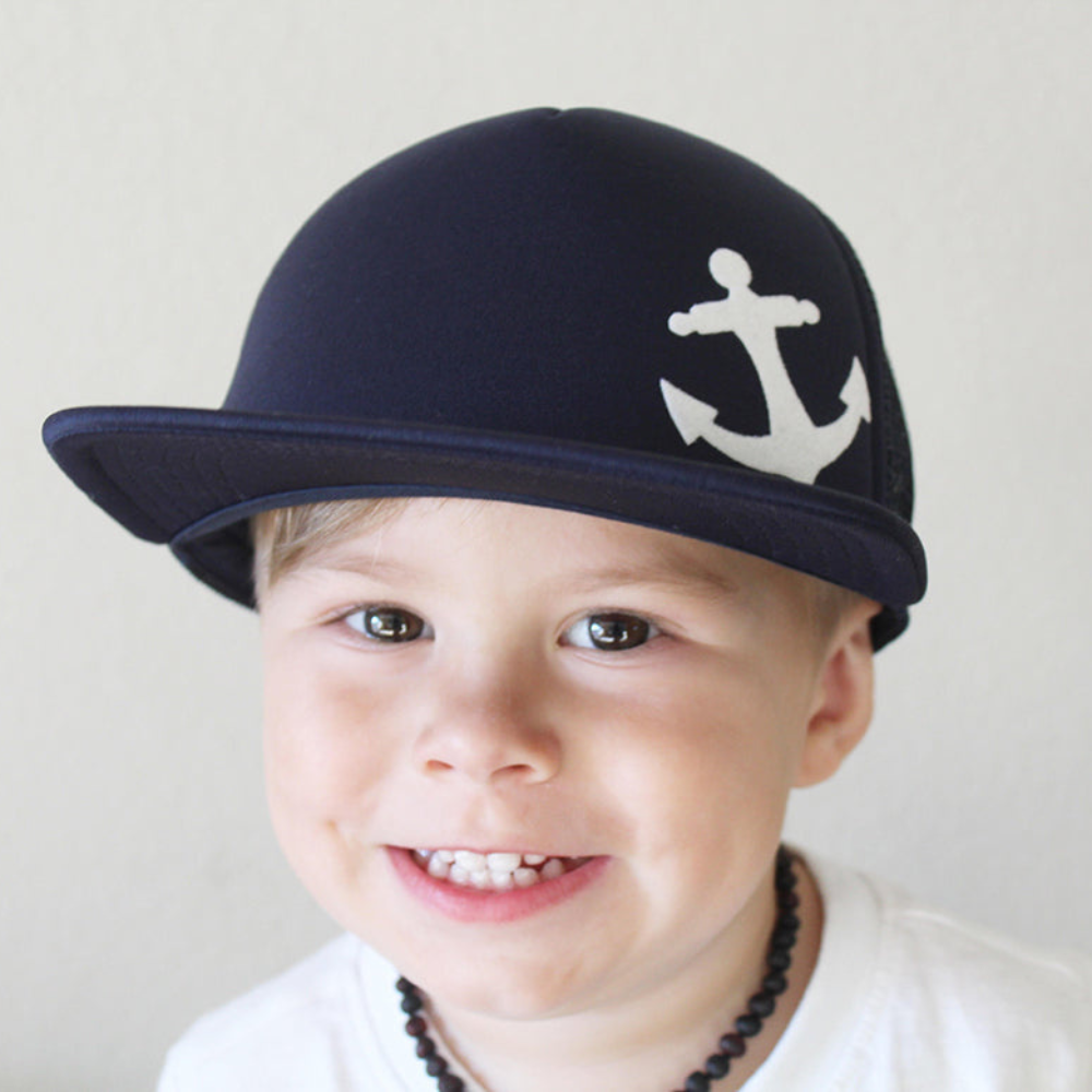 Presenting the Navy Kids Trucker Hat with Anchor Patch and Sun Mesh: A nautical and stylish headwear choice designed for kids. In a timeless navy hue, it features a charming anchor patch on the front and sun mesh for added comfort. Elevate your child's style with this fashionable and practical accessory, ideal for outdoor adventures and everyday wear. Crafted meticulously, this navy trucker hat with the anchor patch and sun mesh is a must-have addition to their wardrobe.