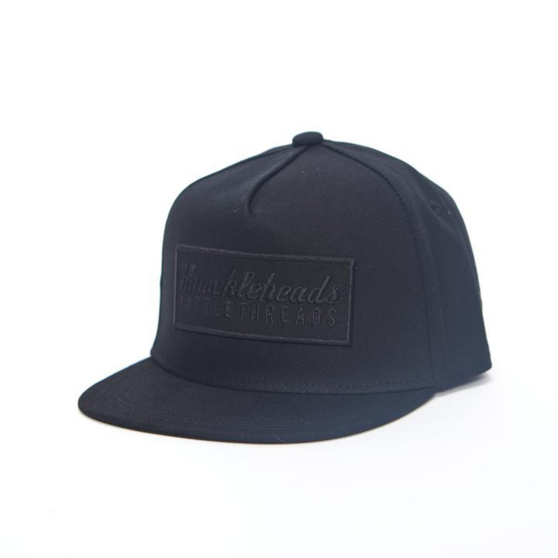 Image of Black Kids Trucker Hat with Black Knuckleheads Patch: A sleek and stylish accessory designed for kids. In classic black, it features a bold black Knuckleheads patch on the front. Elevate your child's style with this fashionable hat, perfect for adding a touch of edgy flair to their outfits. Crafted with care, this black kids trucker hat with the black Knuckleheads patch is a must-have addition to their wardrobe, suitable for various occasions and everyday wear.