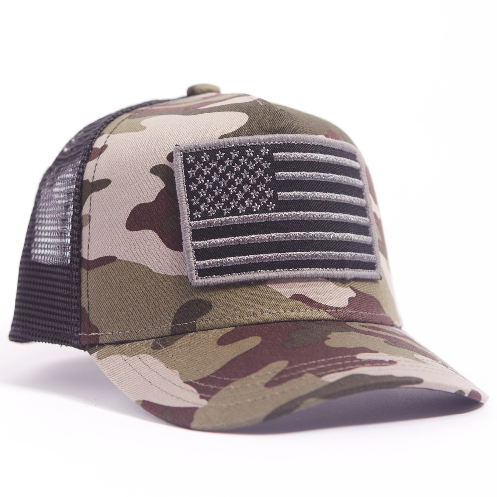 Image of Camo Kids Trucker Hat with USA Flag Patch: A rugged and patriotic accessory designed for kids. In a classic camo pattern, it features a prominent USA flag patch on the front. Elevate your child's style with this fashionable hat, perfect for showcasing their love for the country. Crafted with care, this camo kids trucker hat with the USA flag patch is a must-have addition to their wardrobe, suitable for various occasions and everyday wear.