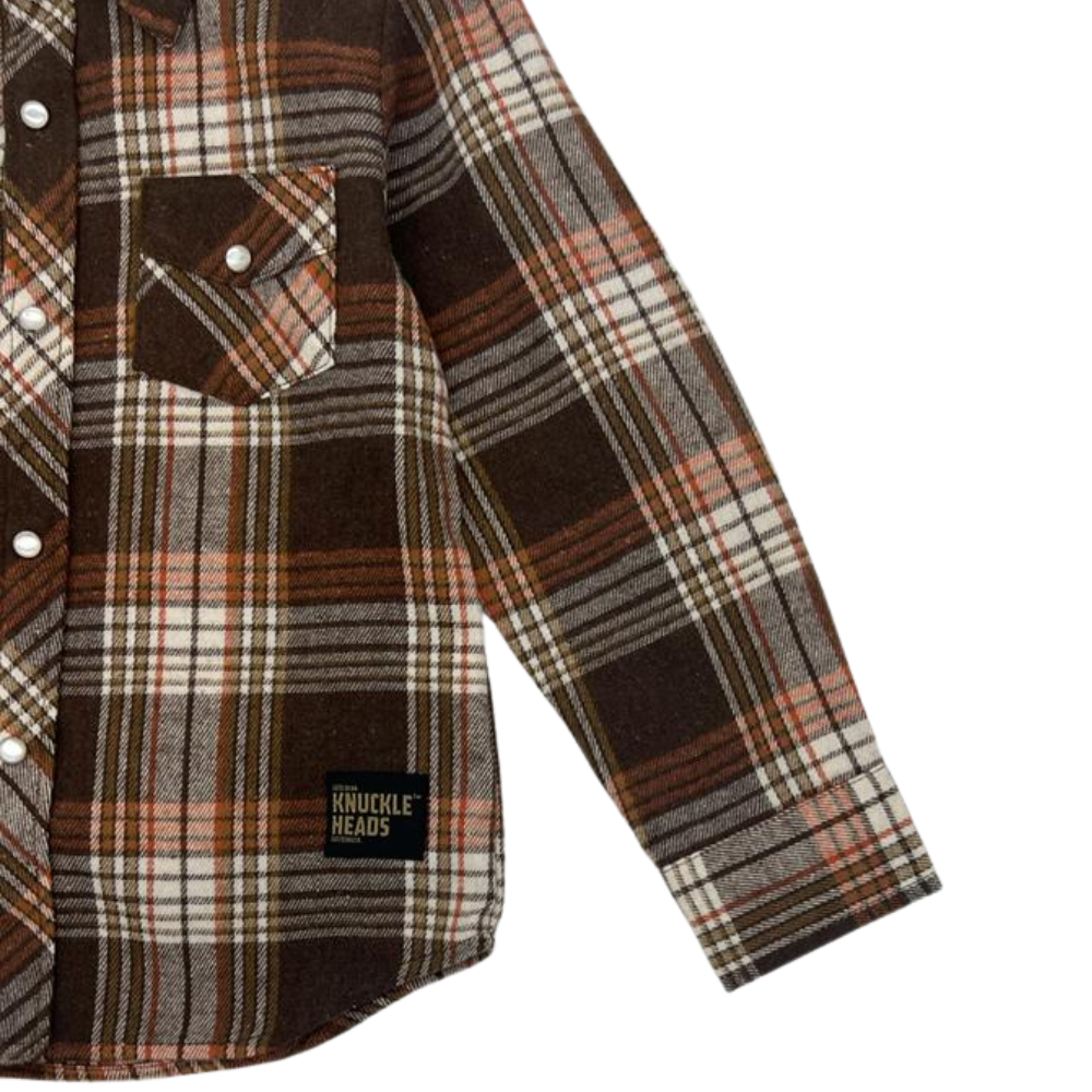 Picture of a stack of cozy flannel long sleeve shirts in various vibrant colors, perfect for kids. The shirts are made with soft, warm flannel material, making them ideal for chilly days. Each shirt features a simple design with a comfortable fit, perfect for layering or wearing on its own. Shop now to keep your kids comfortable and stylish during the cooler months.