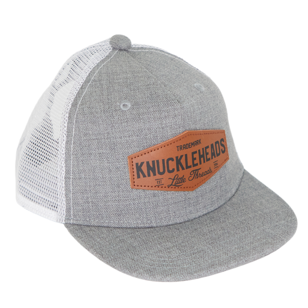 Image of Grey Kids Trucker Hat with White Mesh and Knuckleheads Patch: A modern and stylish accessory designed for kids. In sleek grey with white mesh, it showcases a striking Knuckleheads patch on the front. Elevate your child's style with this fashionable hat, perfect for adding a touch of flair to their outfits while ensuring breathability. 