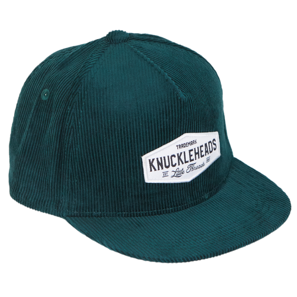 Image of Green Corduroy Kids Trucker Hat with Knuckleheads Patch: A vintage-inspired and stylish accessory designed for kids. In a rich green corduroy fabric, it showcases a striking Knuckleheads patch on the front. Elevate your child's style with this fashionable hat, perfect for adding a touch of texture to their outfits.