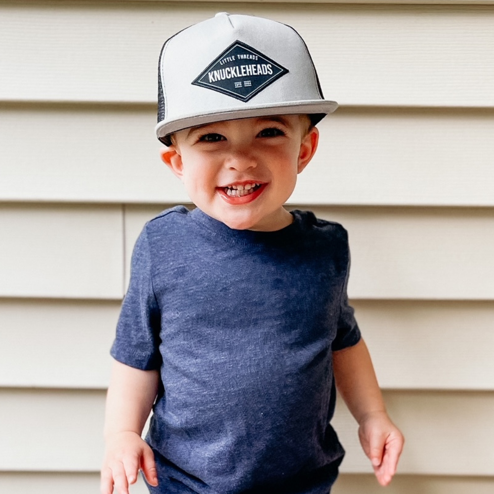 Image of Grey Kids Trucker Hat with Knuckleheads Patch: A stylish and versatile accessory designed for kids. In classic grey, it showcases a striking Knuckleheads patch on the front. Elevate your child's style with this fashionable hat, perfect for adding a touch of edgy flair to their outfits. Crafted with care, this grey kids trucker hat with the Knuckleheads patch is a must-have addition to their wardrobe, suitable for various occasions and everyday wear.