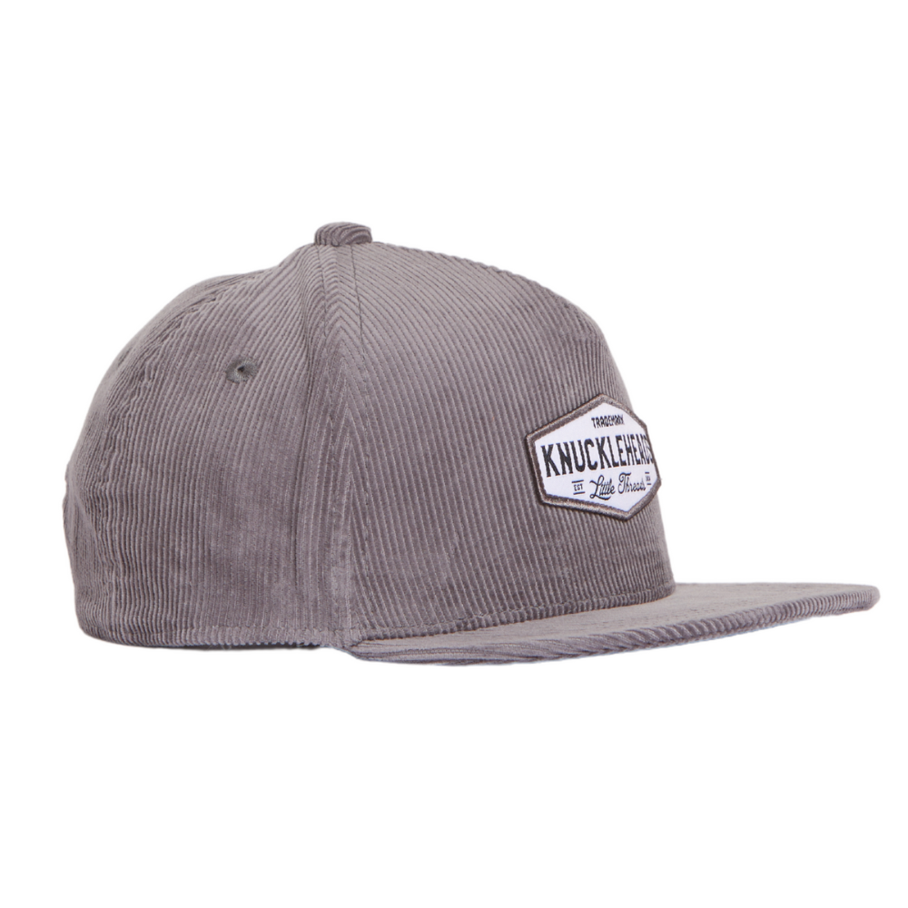 Image of Grey Corduroy Kids Trucker Hat with Knuckleheads Patch: A trendy and chic trucker hat designed for kids. The hat features a stylish grey corduroy fabric, adorned with a cool Knuckleheads patch on the front. Elevate your child's style with this fashionable and comfortable accessory, perfect for any outing or everyday wear. Crafted with care, this grey corduroy trucker hat with a Knuckleheads patch is a must-have addition to their wardrobe.