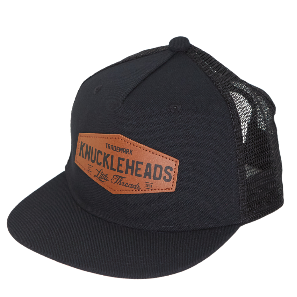 Image of Black Kids Trucker Hat with Brown Knuckleheads Patch: A hip and stylish trucker hat designed for kids. The hat comes in sleek black, accentuated with a chic brown Knuckleheads patch on the front. Elevate your child's style with this trendy and versatile accessory, perfect for any adventure or everyday wear. Crafted with comfort in mind, this black trucker hat with a brown patch is a must-have addition to their wardrobe.