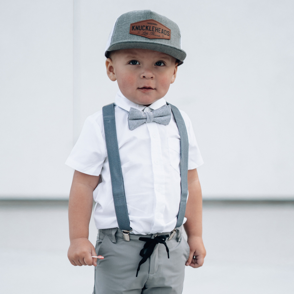Image of Grey Kids Trucker Hat with White Mesh and Knuckleheads Patch: A modern and stylish accessory designed for kids. In sleek grey with white mesh, it showcases a striking Knuckleheads patch on the front. Elevate your child's style with this fashionable hat, perfect for adding a touch of flair to their outfits while ensuring breathability. 