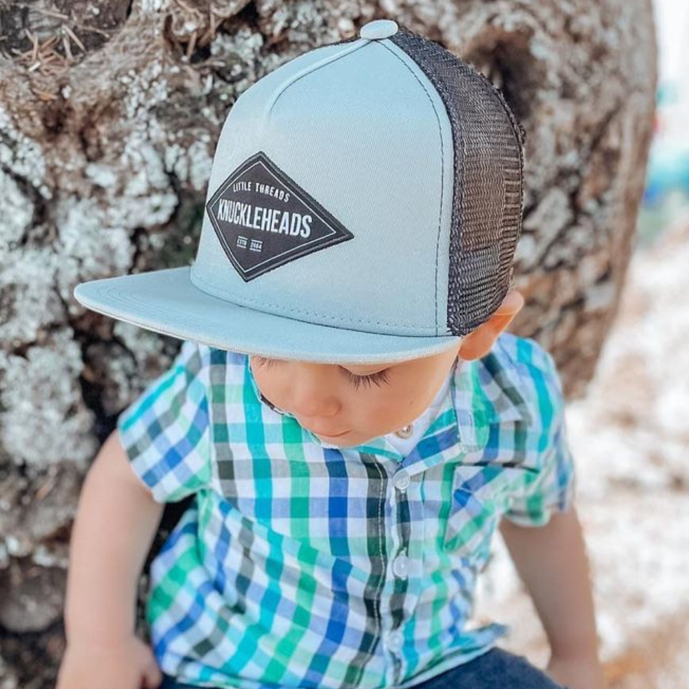 Image of Grey Kids Trucker Hat with Knuckleheads Patch: A stylish and versatile accessory designed for kids. In classic grey, it showcases a striking Knuckleheads patch on the front. Elevate your child's style with this fashionable hat, perfect for adding a touch of edgy flair to their outfits. Crafted with care, this grey kids trucker hat with the Knuckleheads patch is a must-have addition to their wardrobe, suitable for various occasions and everyday wear.