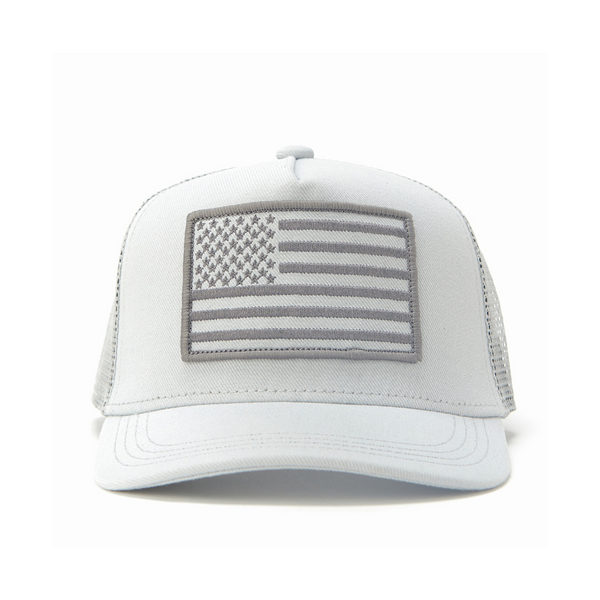 "Image of Kids Trucker Hat with White Mesh and USA Flag Patch: A patriotic and stylish accessory designed for kids. In clean white with matching white mesh, it features a prominent USA flag patch on the front. Elevate your child's style with this fashionable hat, perfect for adding a touch of national pride to their outfits while ensuring breathability. 