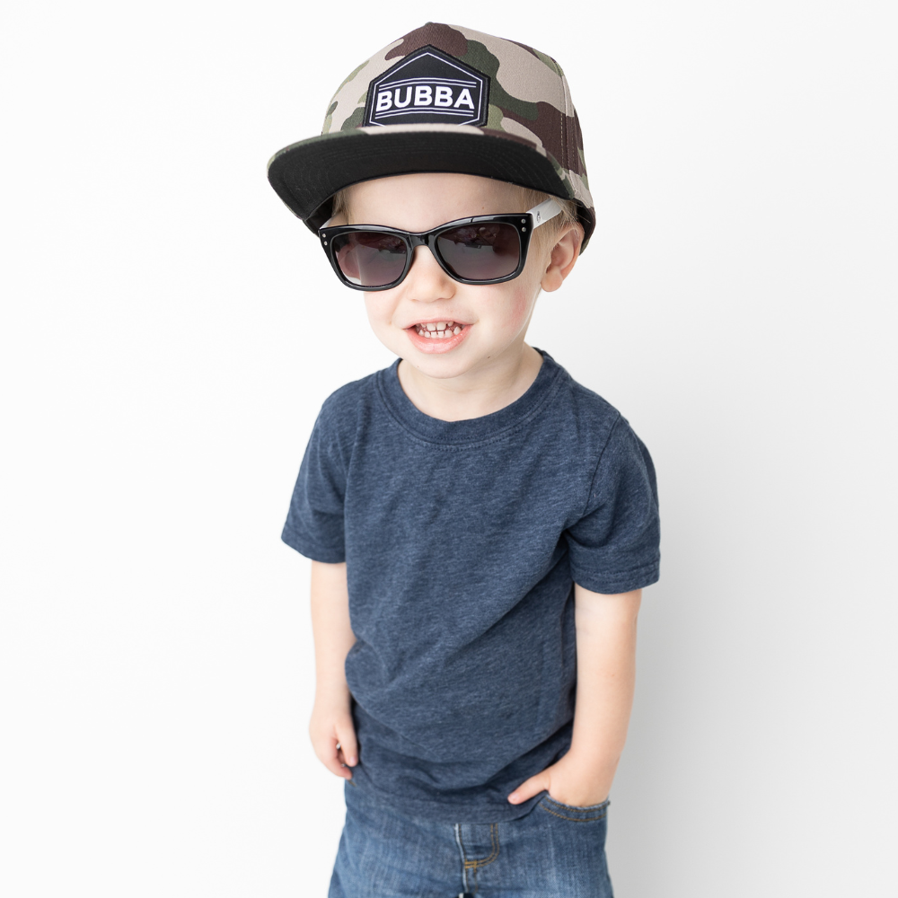 Image of Camo Kids Trucker Hat with 'Bubba' Patch: A cool and adventurous trucker hat designed for kids. The hat features a stylish camo print, complemented by a charming 'Bubba' patch on the front. Elevate your child's style with this trendy and fun accessory, perfect for outdoor explorations and everyday wear. Crafted with comfort in mind, this camo trucker hat is a must-have addition to their wardrobe.