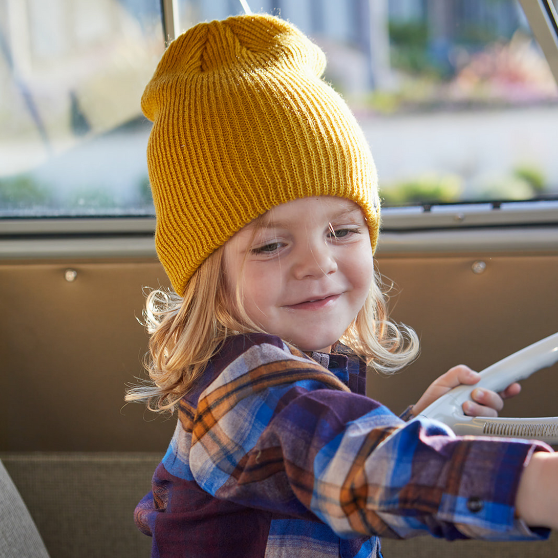 Image highlighting a vibrant yellow beanie from Knuckleheads, designed for children. This versatile beanie, complete with the Knuckleheads brand tag, offers a classic style suitable for infants and toddlers. A cheerful addition to the collection of Infant hats, adding a bright touch of charm.